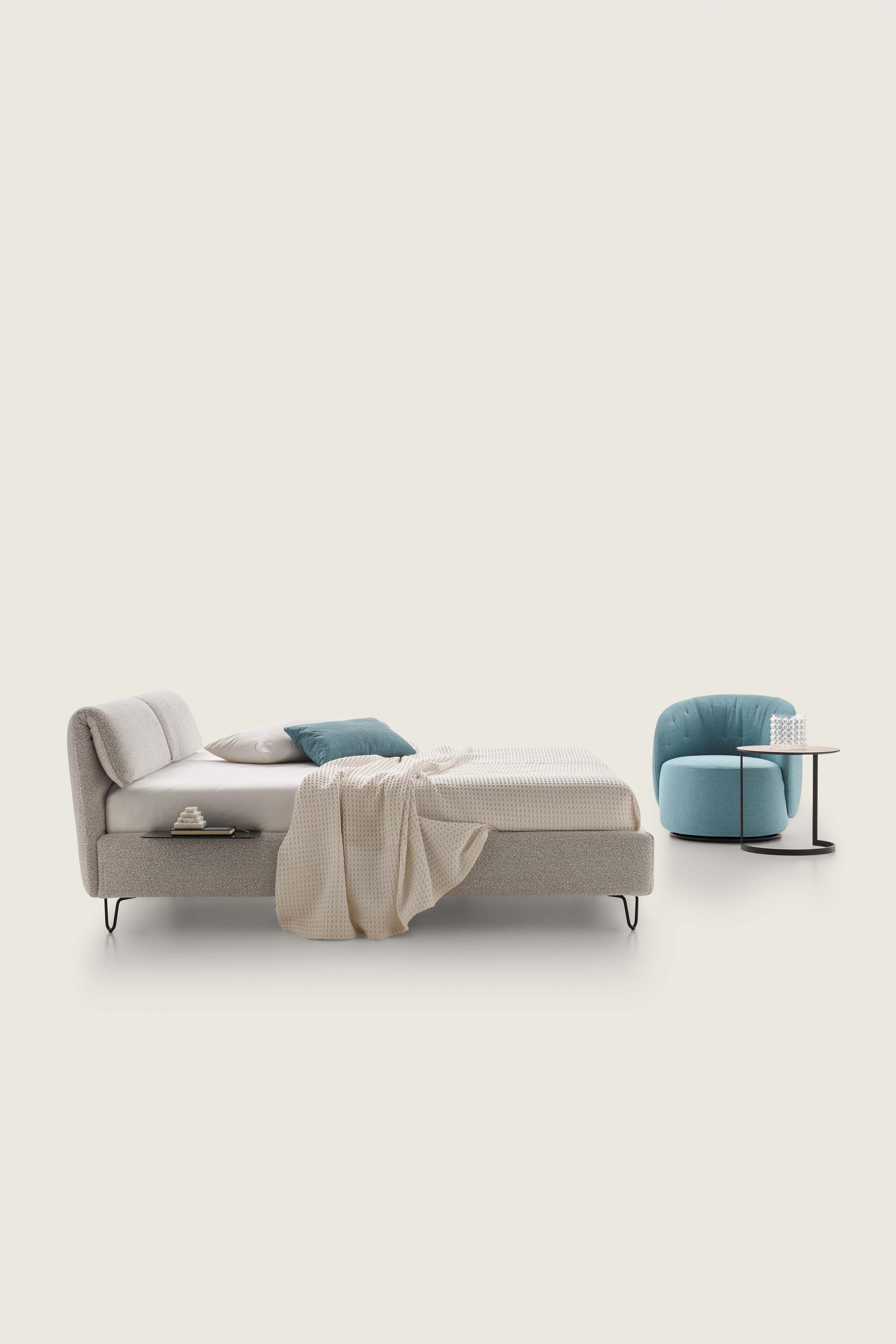 Gray faux-velvet fabric bed with medium-high designer painted metal feet and built-in tray