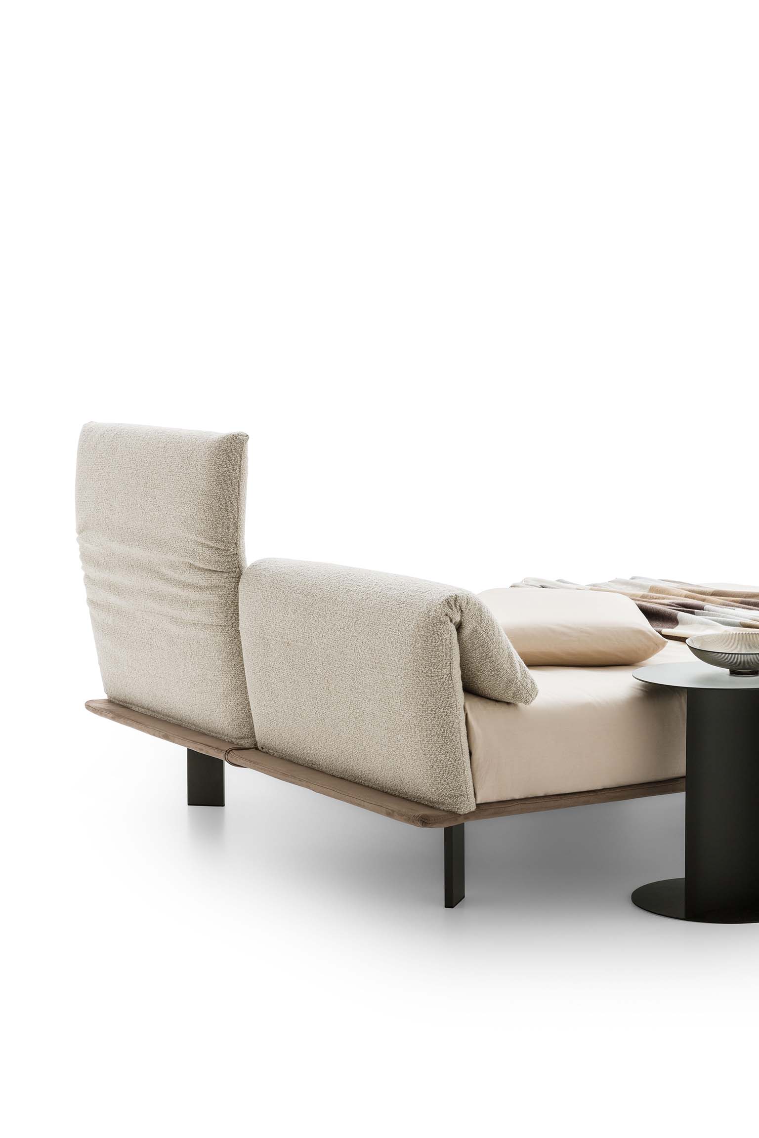 Headboard with cushions that fold onto themselves on a double bed