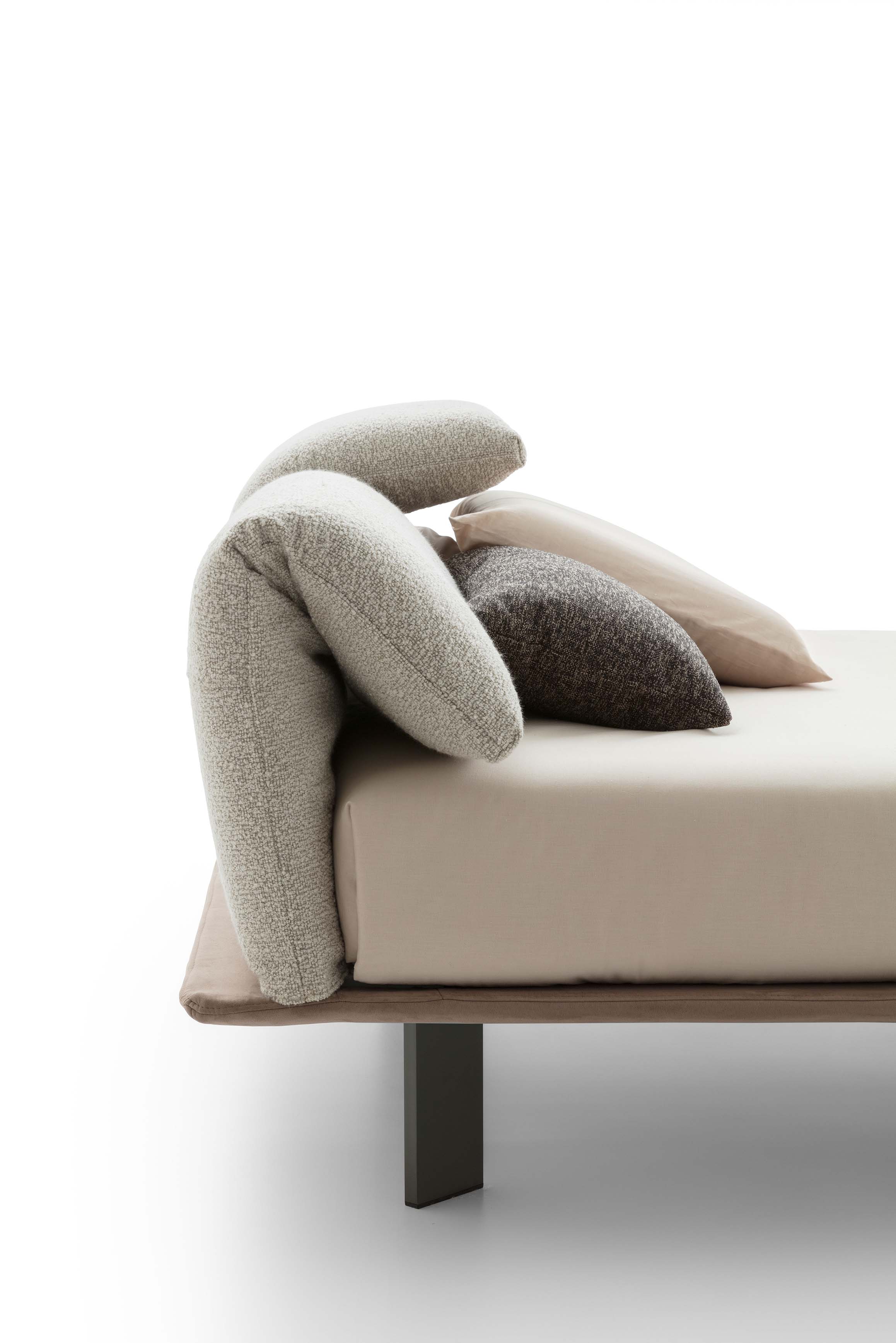 Detail of the headboard with folding cushions of a super modern bed