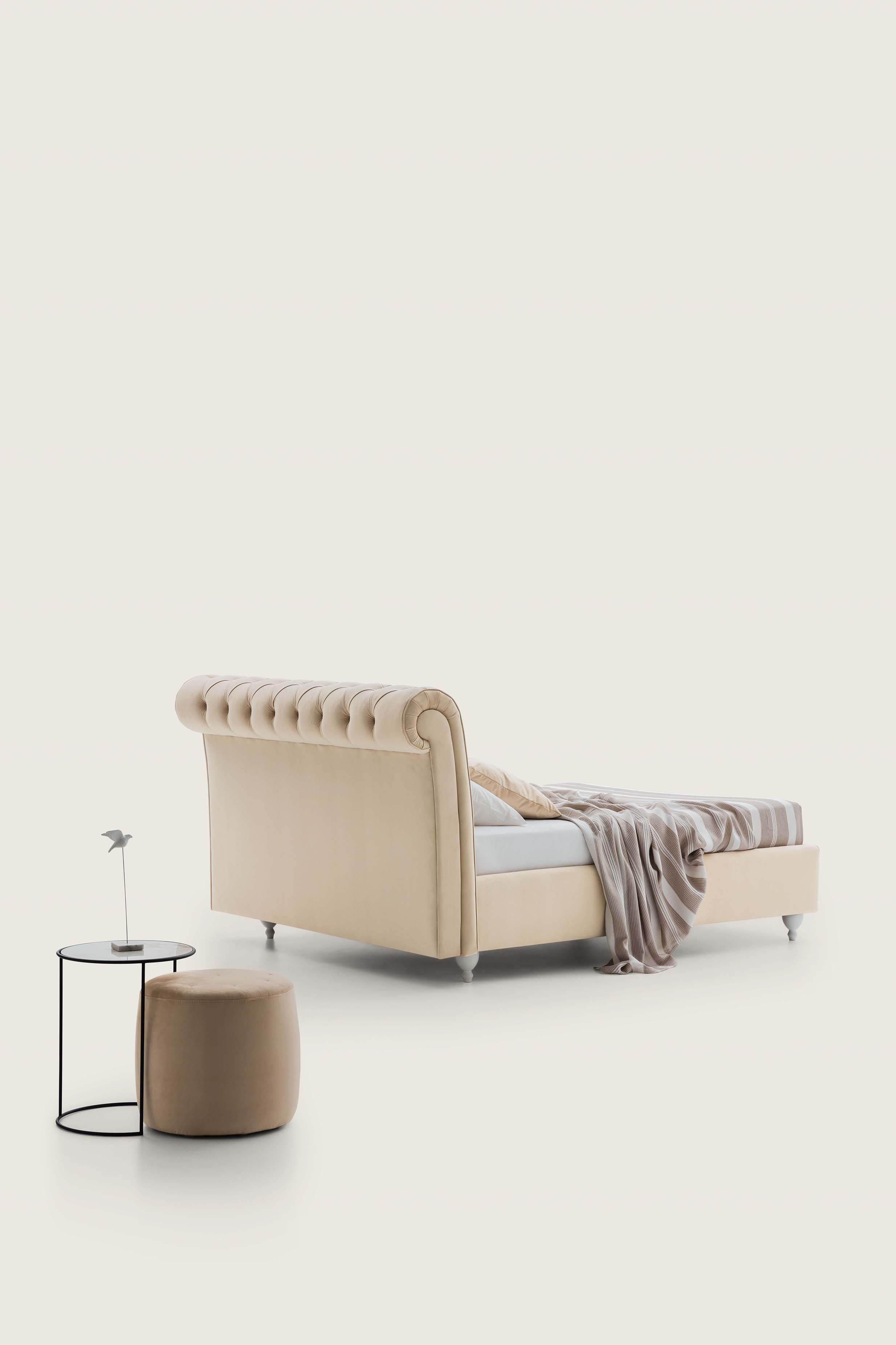 Chesterfield style double bed with rolled headboard and peculiar feet
