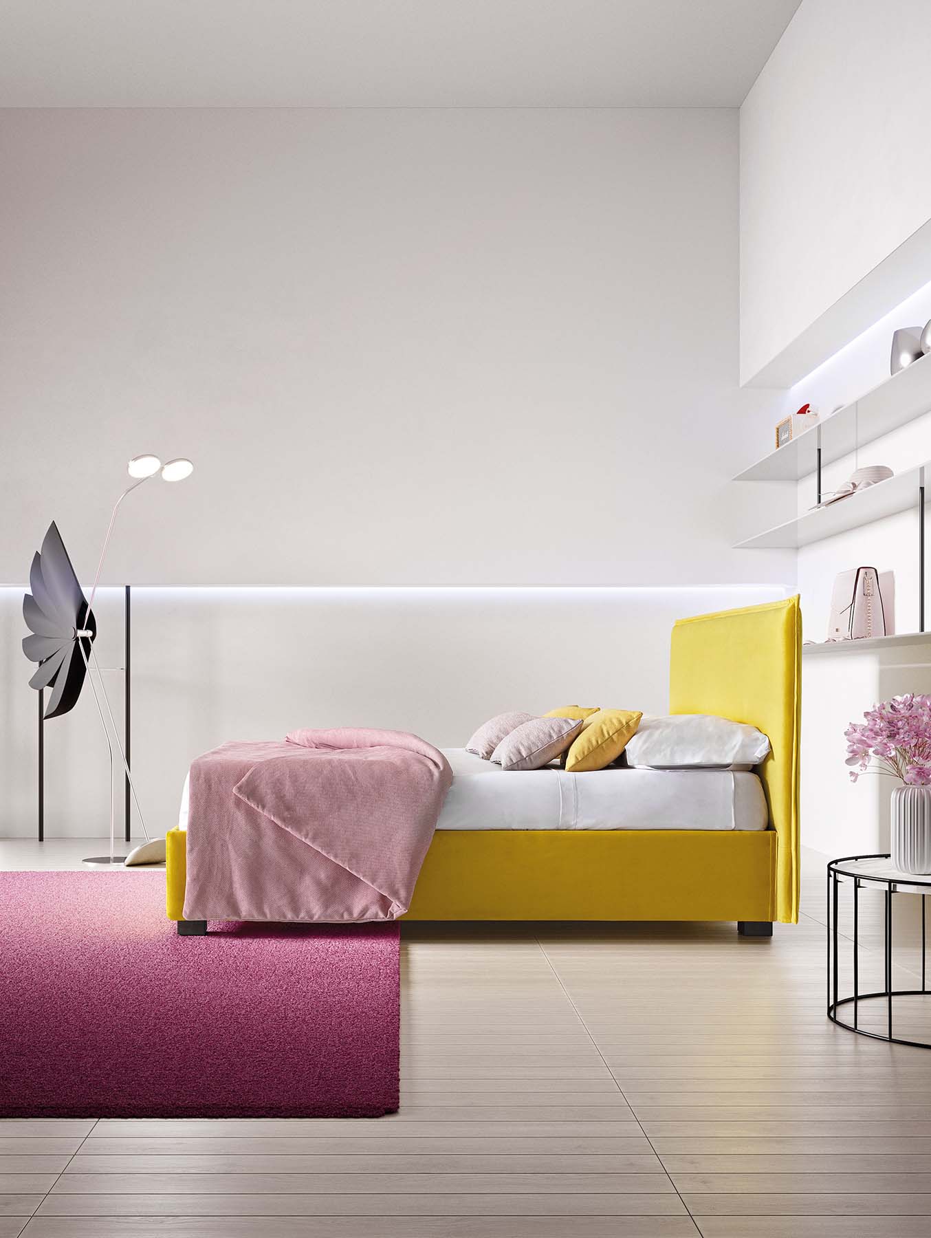 Space-saving yellow bed with very thin headboard