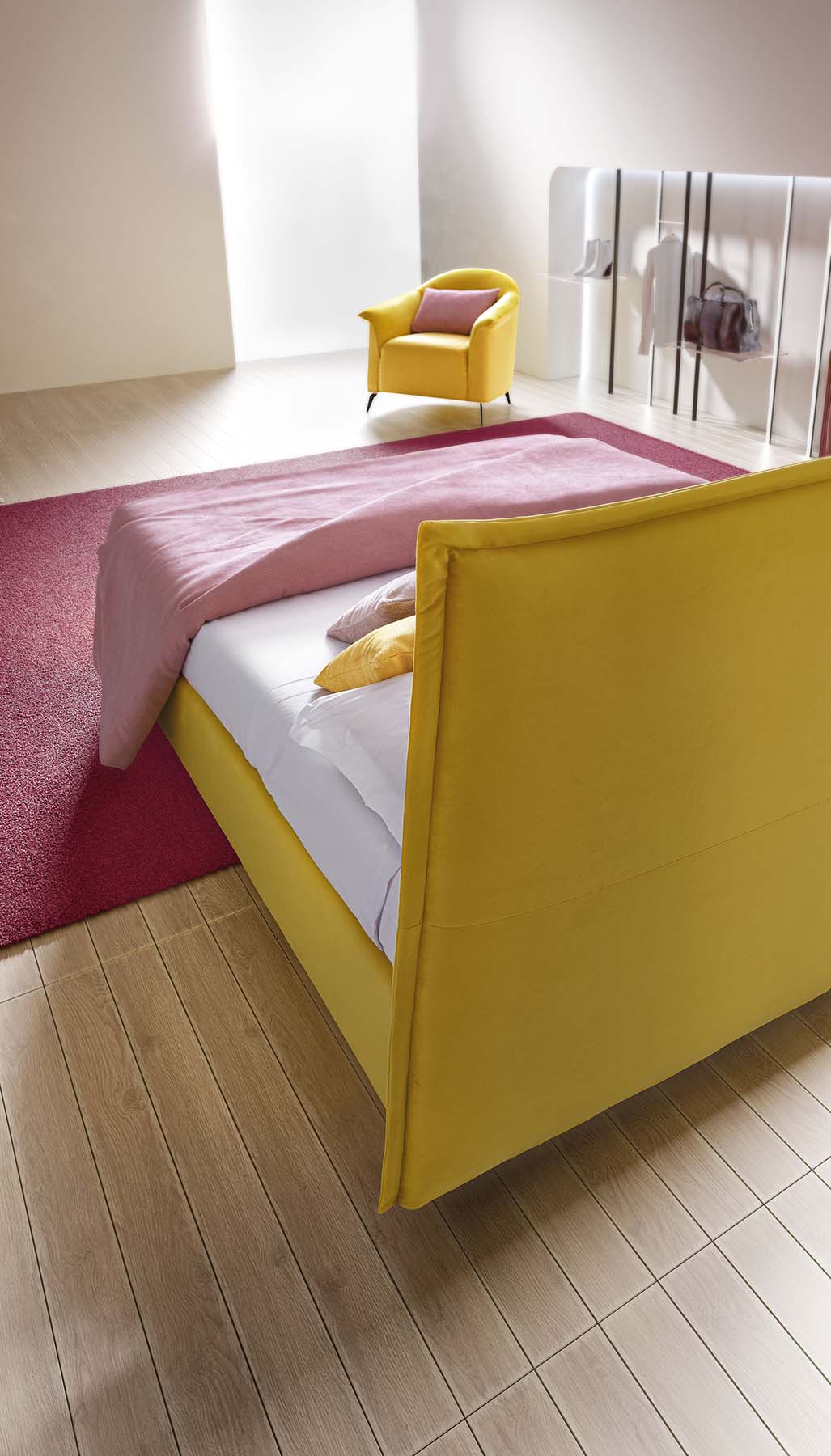 Detail of the headboard of a yellow fabric bed seen from the back