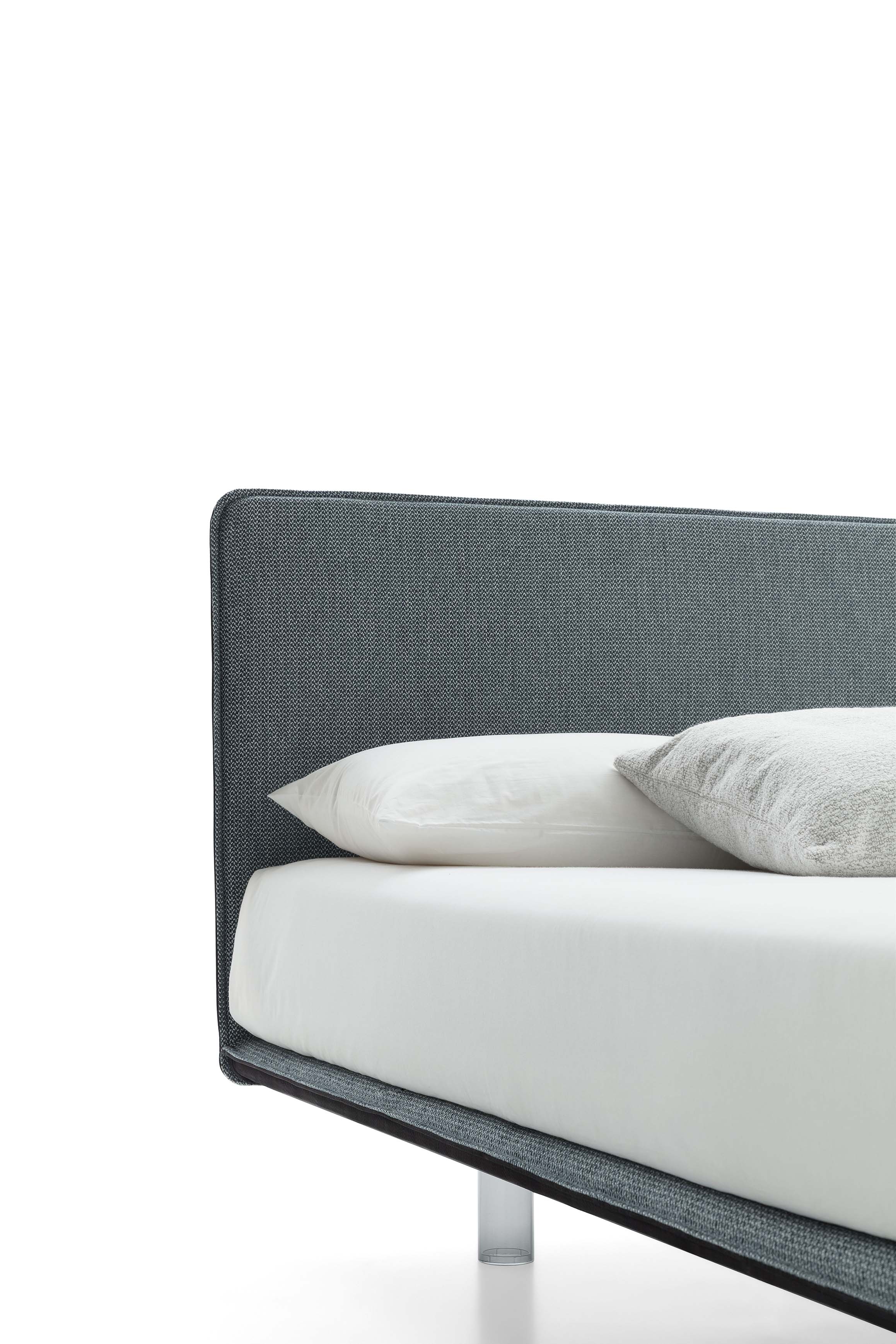 Detail of the very thin headboard of a designer bed with transparent feet