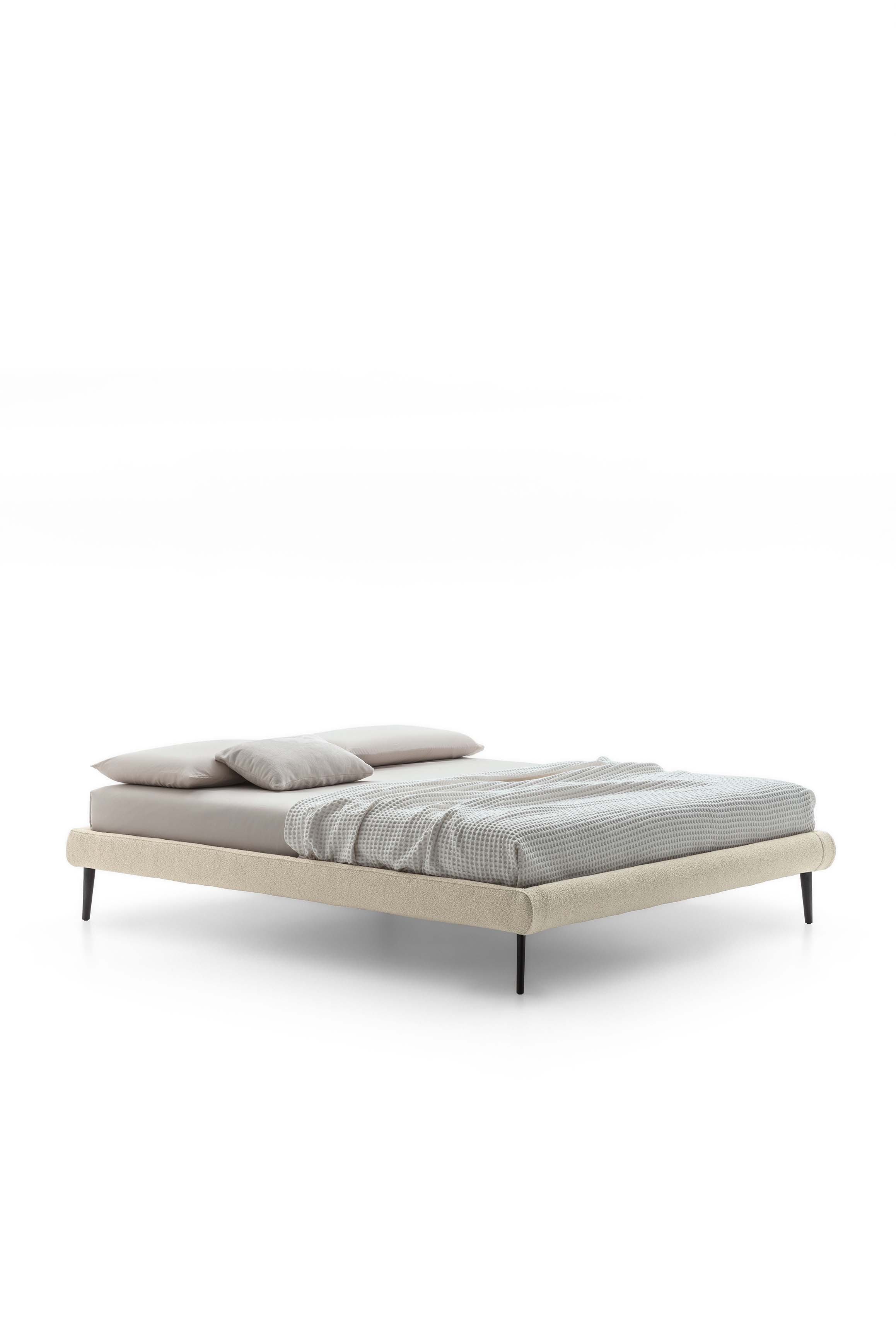 High bed without headboard with high black painted feet