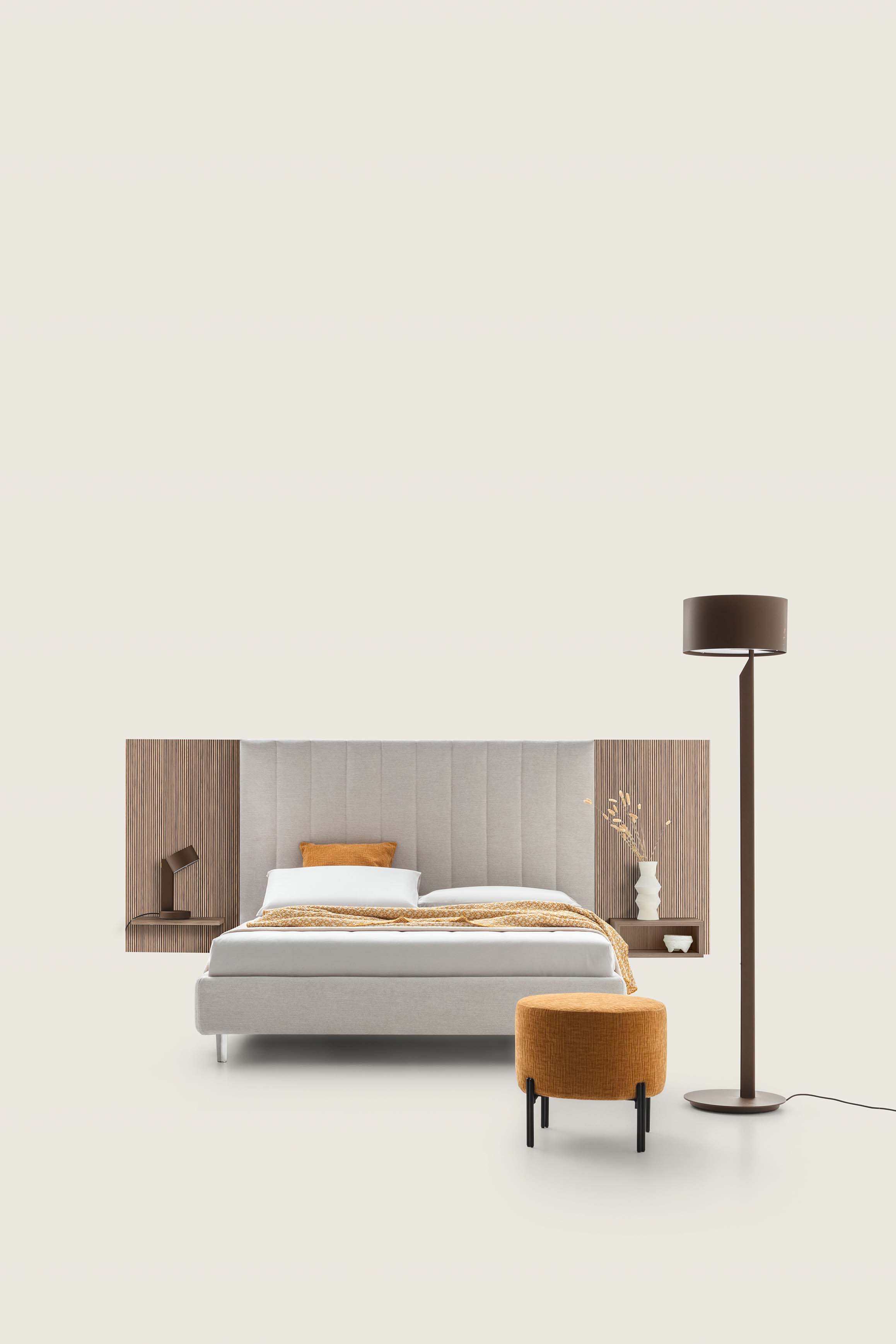 White double bed with wide quilted and wooden headboard with shelves