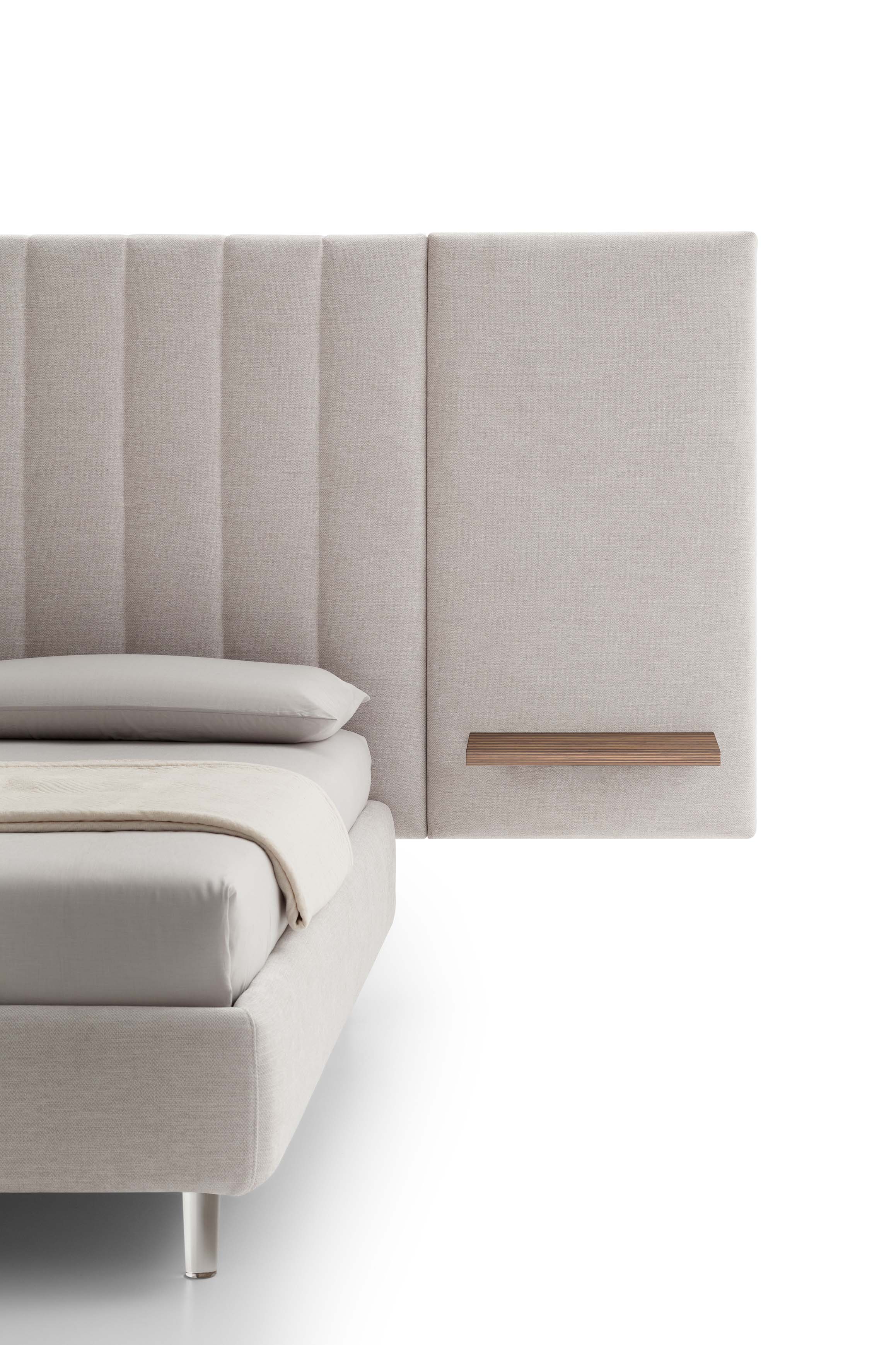 Detail of the upholstered headboard with wooden shelf of a contract bed