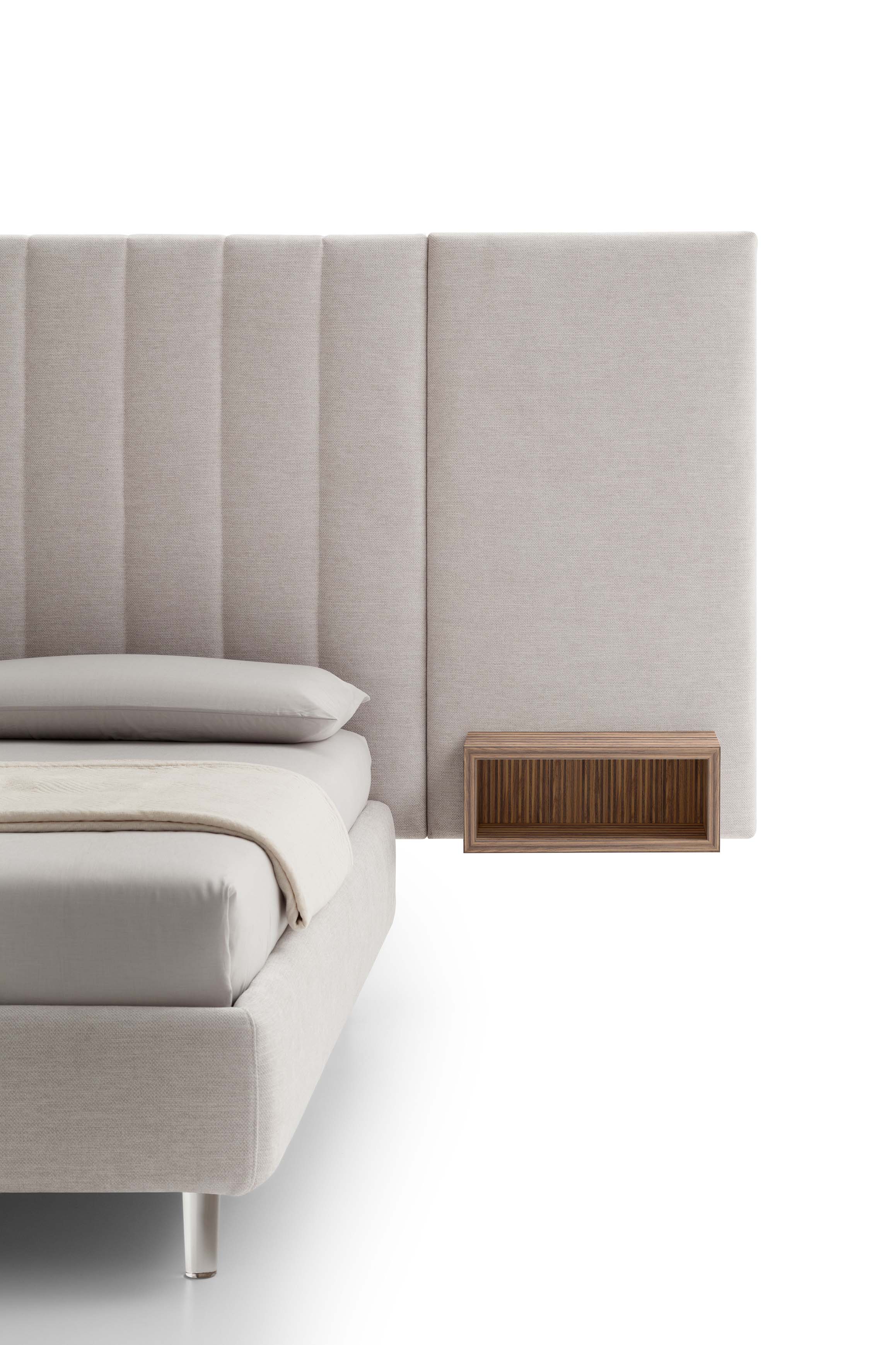 Detail of the upholstered headboard with open compartment of a contract bed