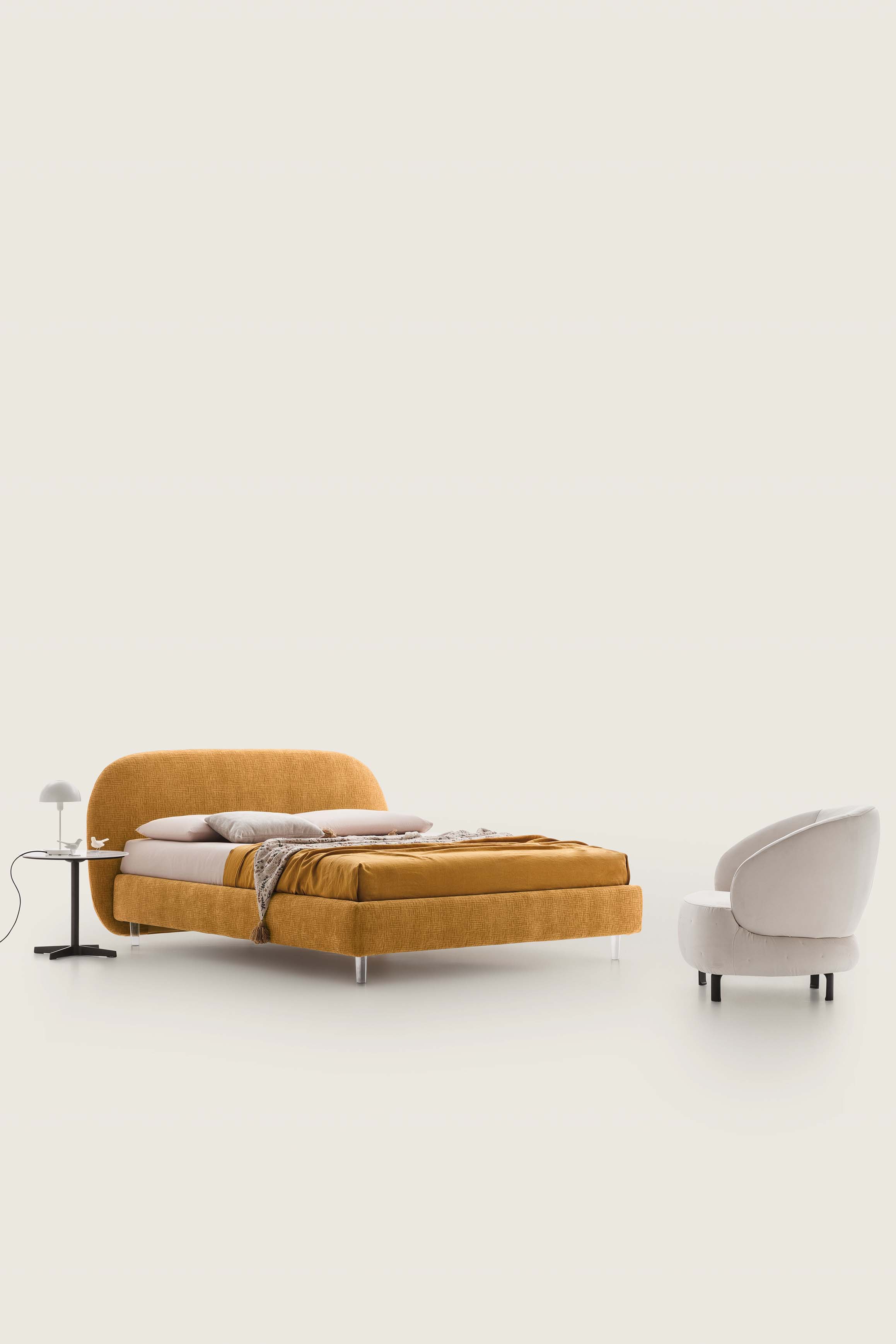 Vintage-style mustard yellow double bed with plexiglass legs