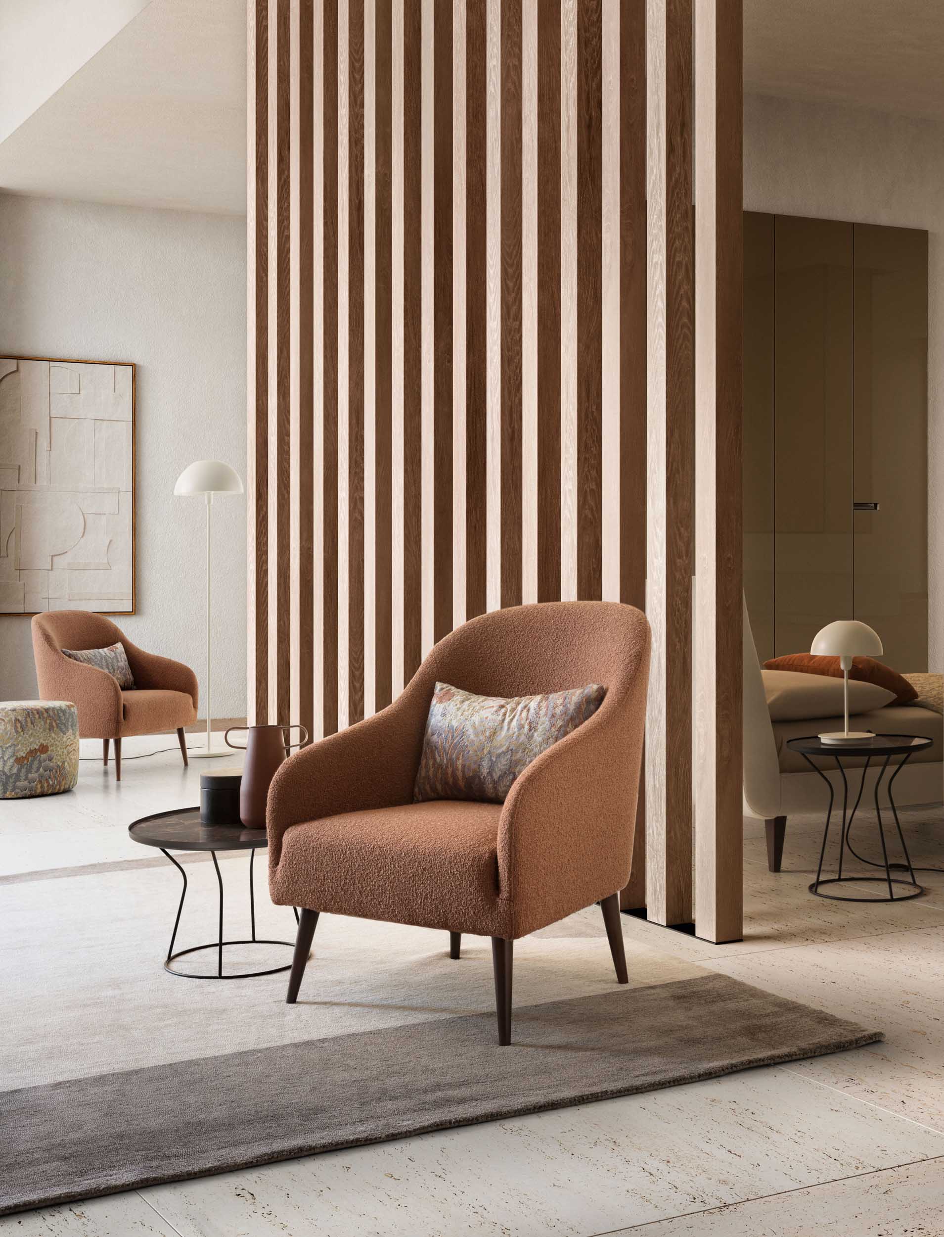 Modern armchair in warm tones with a floreal cushion