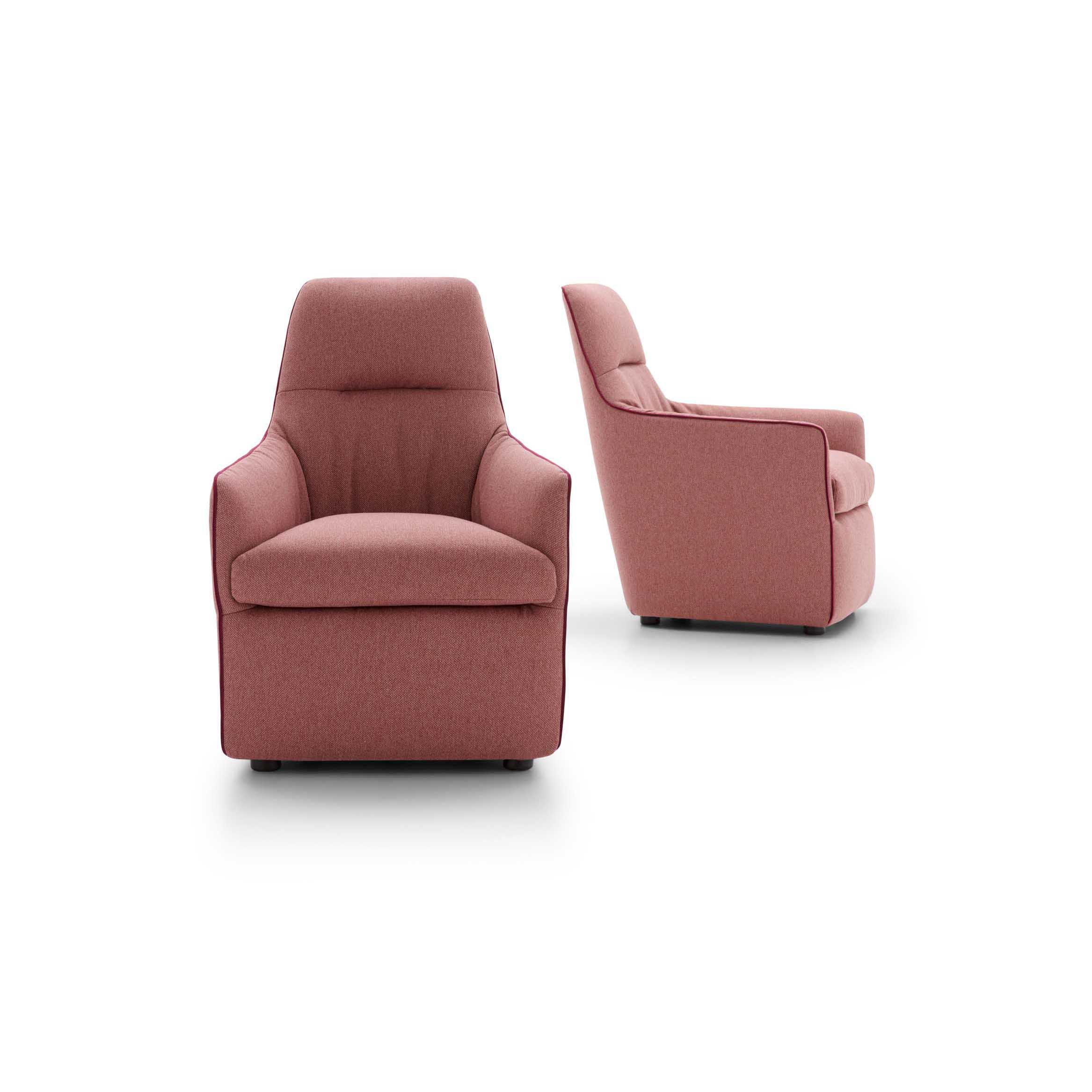 Comfortable coral-colored armchair with armrests and high backrest