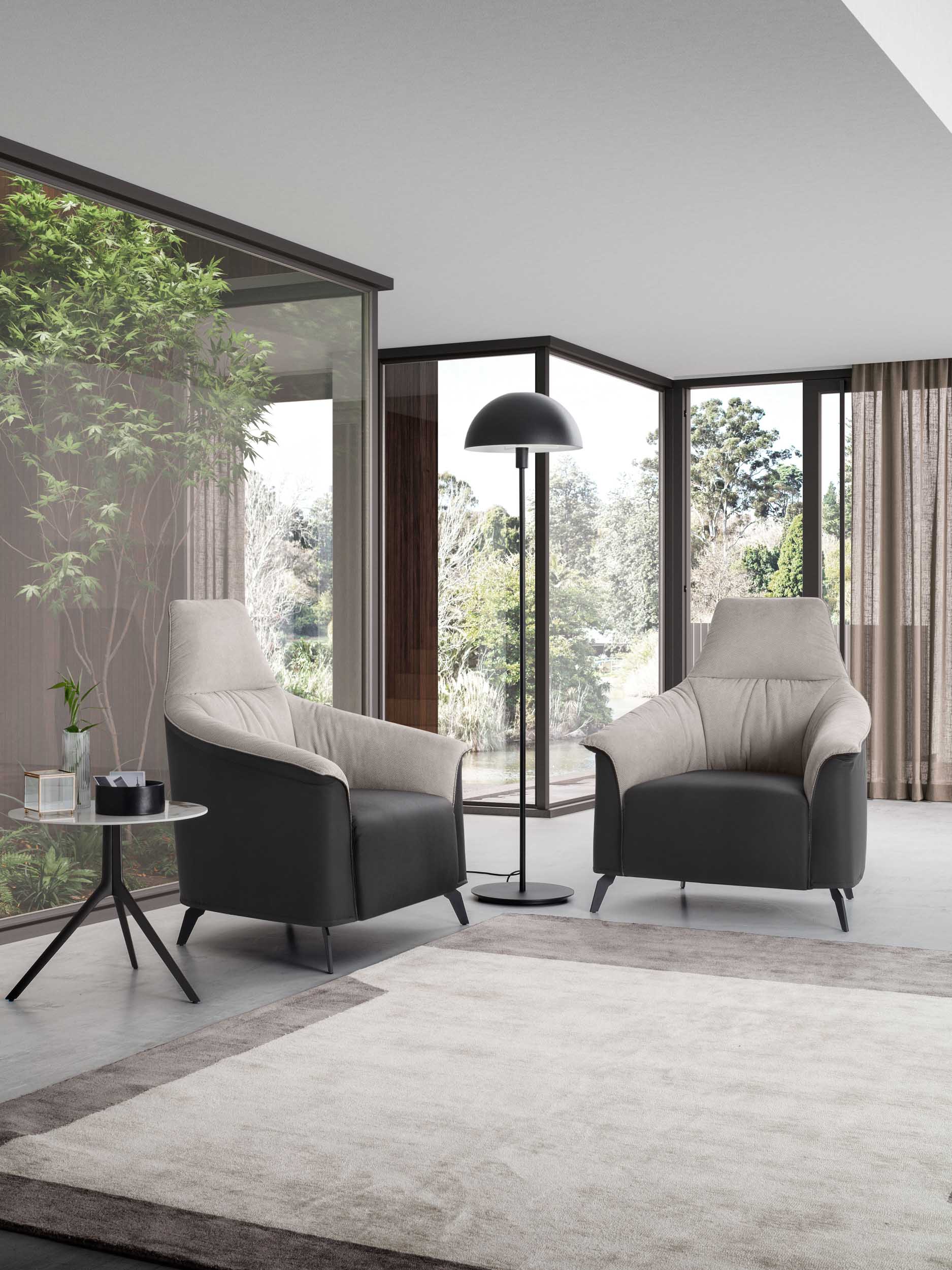 Lounge area with Caroline model armchairs and loveseat in black and white