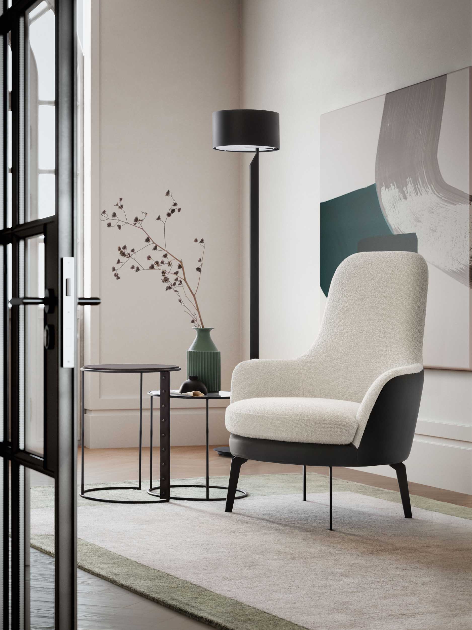 White armchair with black sides in a modern lounge.