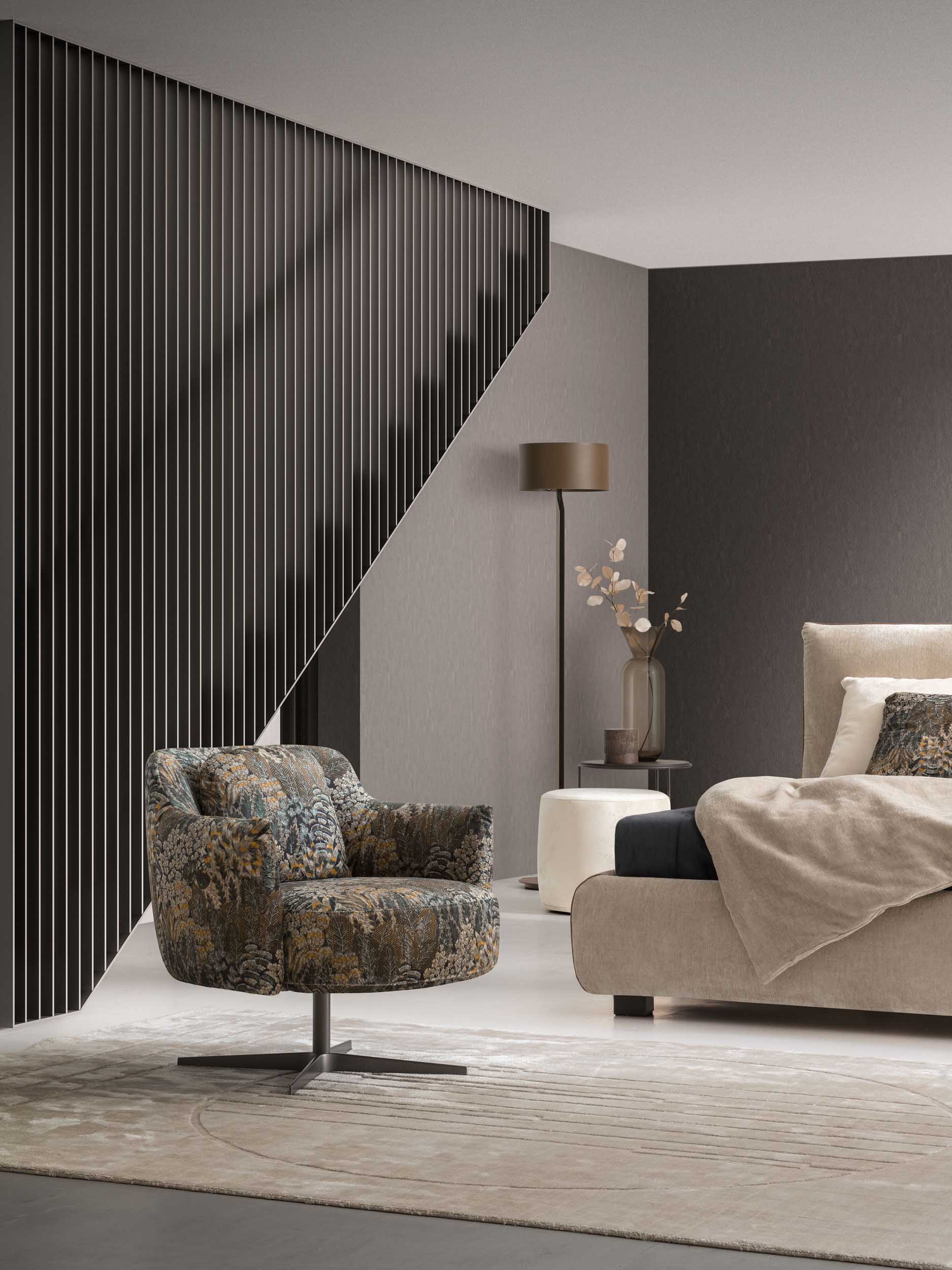 Armchair with multicolored floral upholstery Tenerife 006 in a modern bedroom.