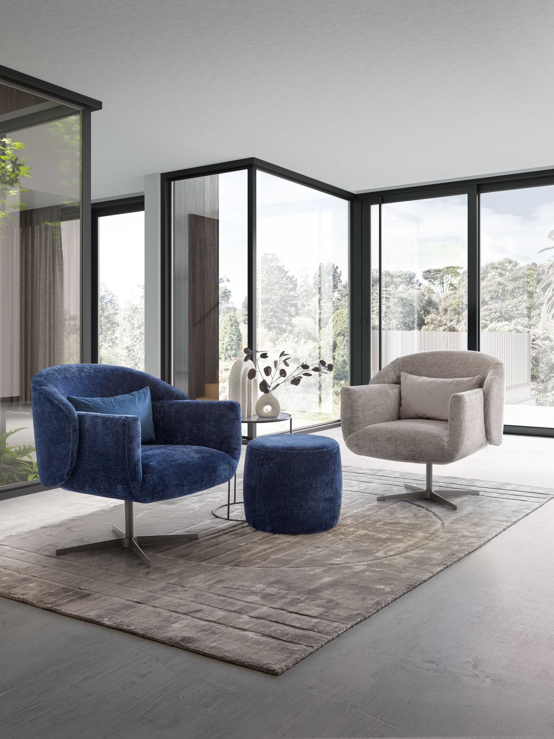 Set of designer swivel armchairs: one silver and the other blue, in a modern living room.