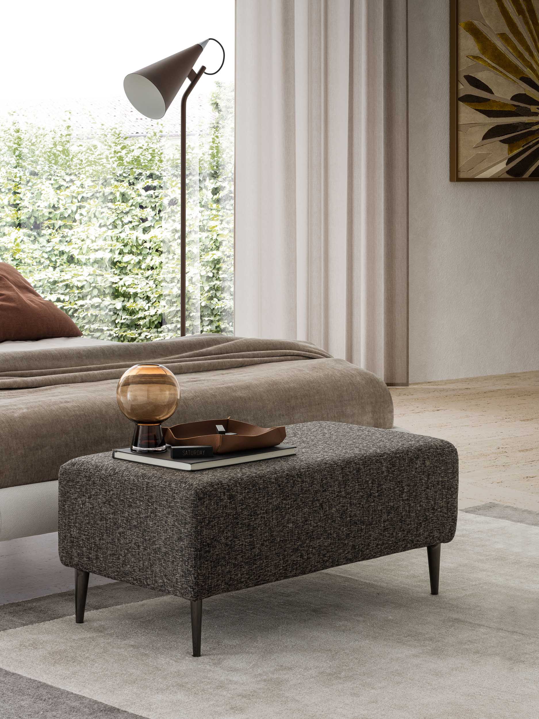 Ottoman used as a bench in the bedroom.