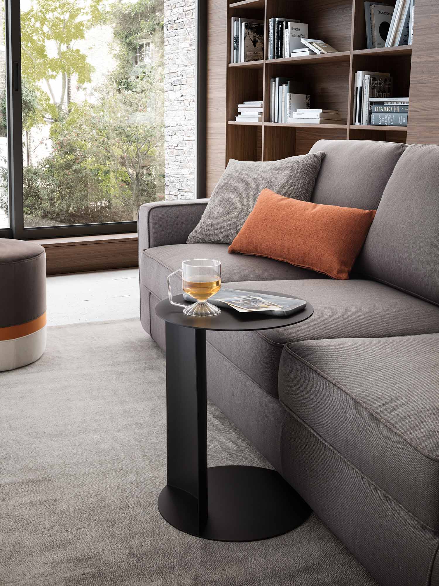 Round coffee table with a nesting structure used in a modern living room.