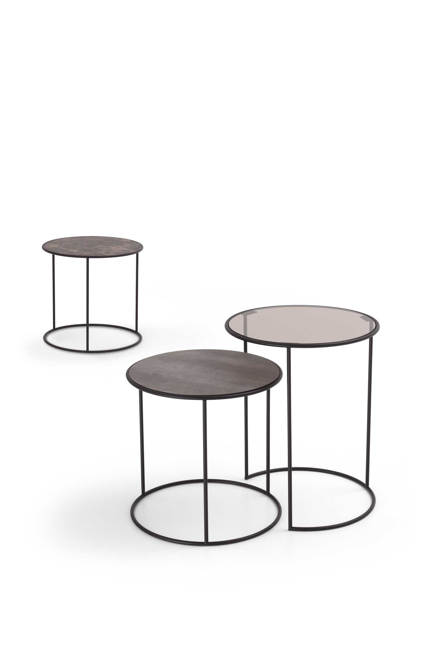 Tables with glass tops and circular metal structures. Nesting shapes.