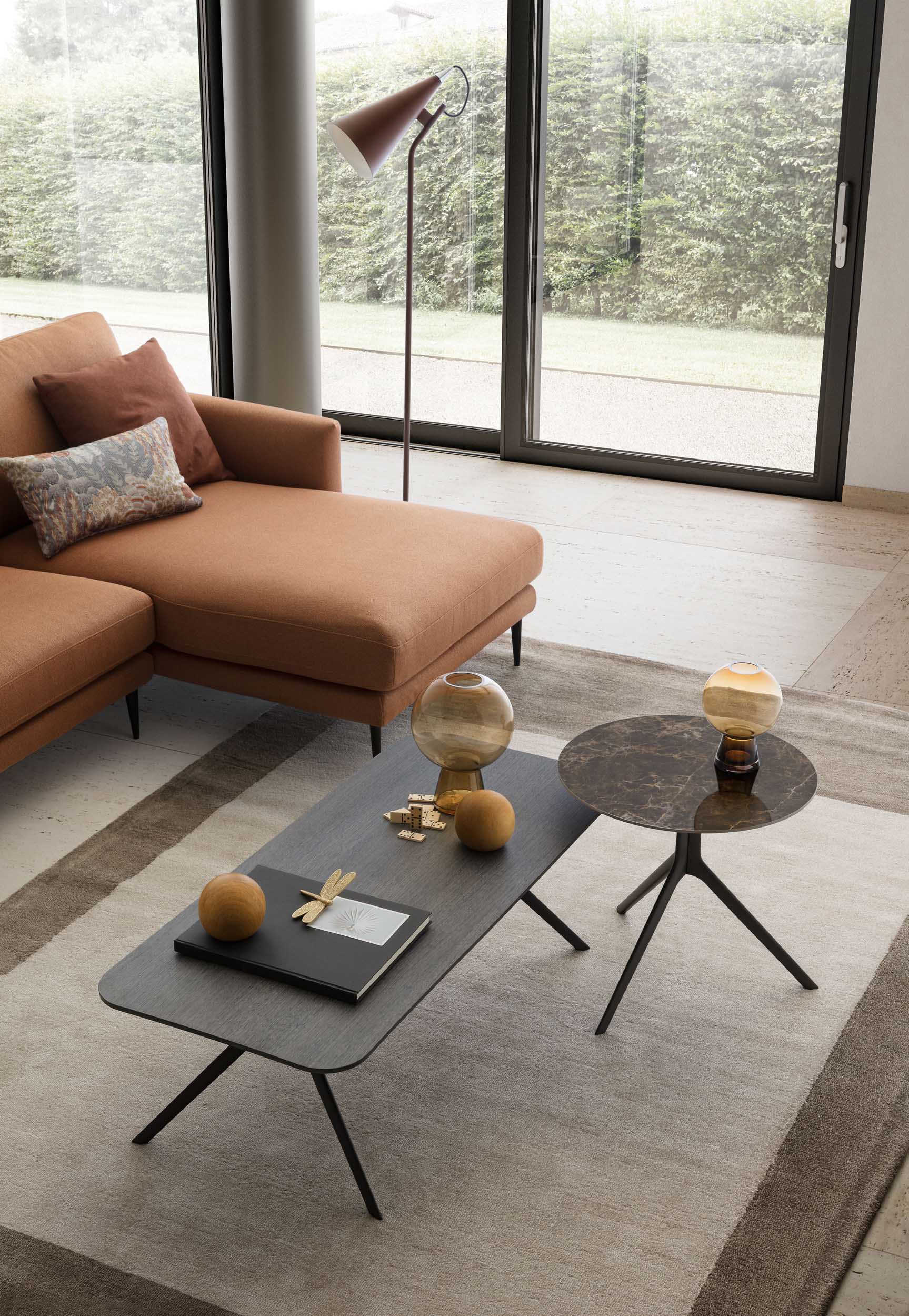 Set of dark coffee tables in various shapes in a modern designer living room