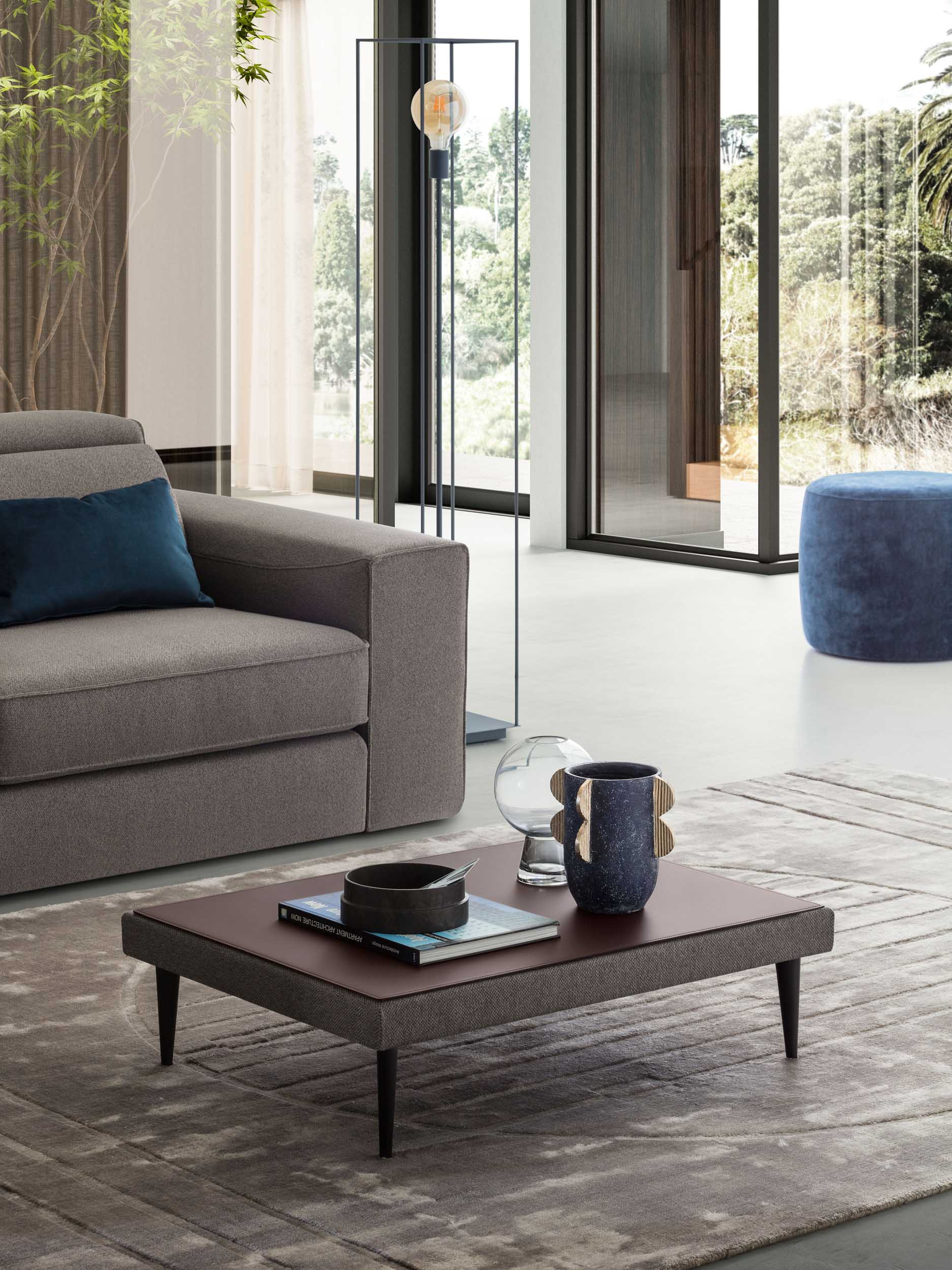 Low rectangular coffee table in a modern living room with a brown top