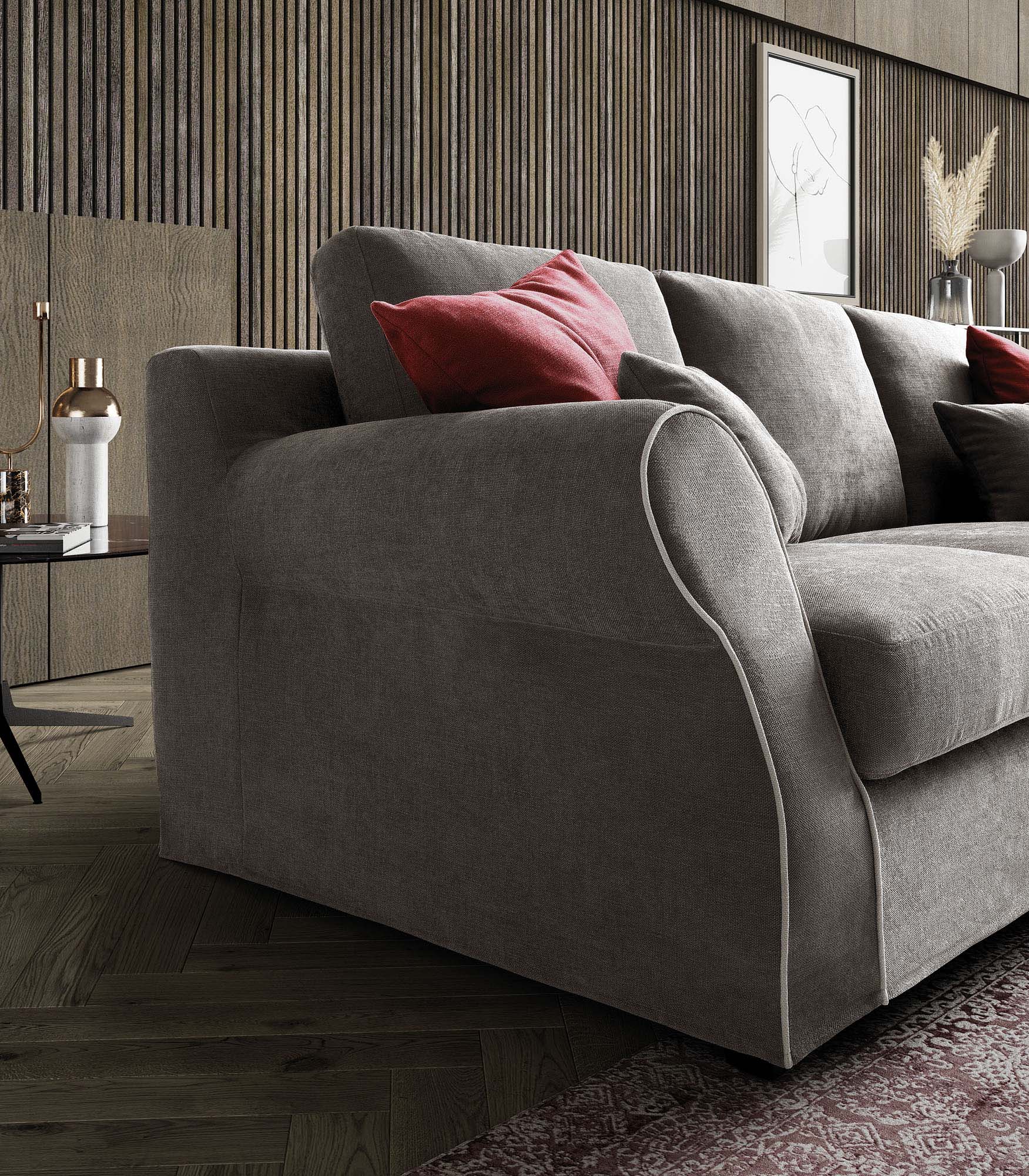 Detail of the grey Abby sofa armrest with contrasting piping