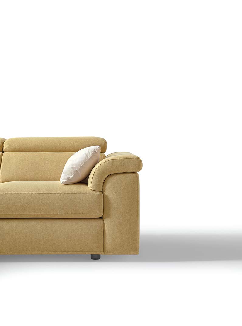 Detail of the curved and soft armrest of a sofa with low feet